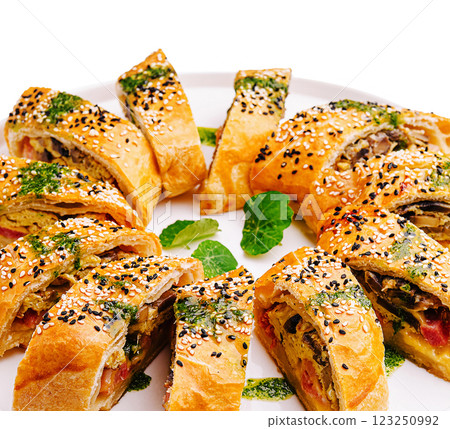 Savory puff pastry rolls filled with vegetables and herbs 123250992
