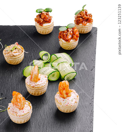 Delicious seafood appetizers displayed on a slate platter Delicious seafood appetizers displayed on a slate platter 123251139