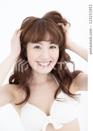 A woman touching her hair A woman touching her hair 123251951