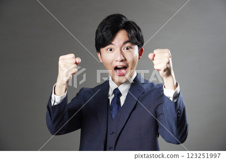 Businessman cheering black background 123251997