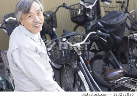 Man in work clothes with bicycle 123252056