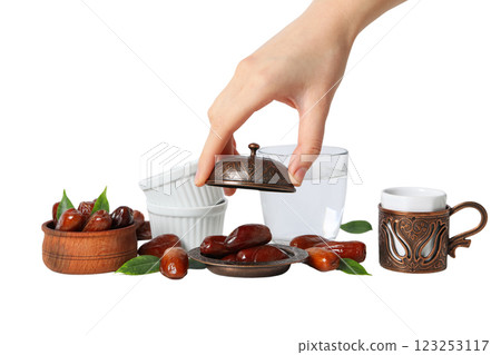Dried dates in bronze and wooden bowl, ceramic bowls, glass of water and authentic cup and hand, isolated on white background, PNG Dried dates in bronze and wooden bowl, ceramic bowls, glass of water and authentic cup and hand, isolated on white background, PNG 123253117