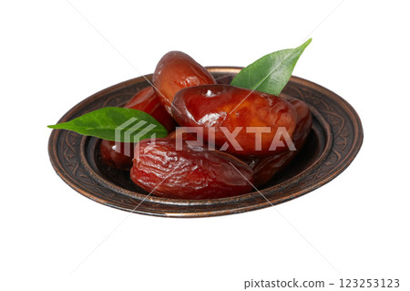 Dried dates in a bronze authentic saucer, close up, isolated on white background, PNG 123253123