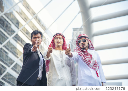 Arab team hold digital tablet uae union teamwork people. Digital marketing arab group of people using smart tablet discuss modern muslim UAE city. Entrepreneur Asian people smile teams meeting. Arab team hold digital tablet uae union teamwork people. Digital marketing arab group of people using smart tablet discuss modern muslim UAE city. Entrepreneur Asian people smile teams meeting. 123253176