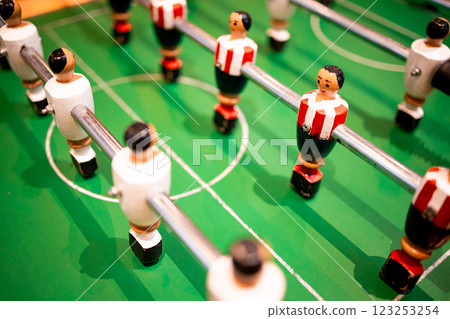 Table soccer game with colorful players on green field Table soccer game with colorful players on green field 123253254