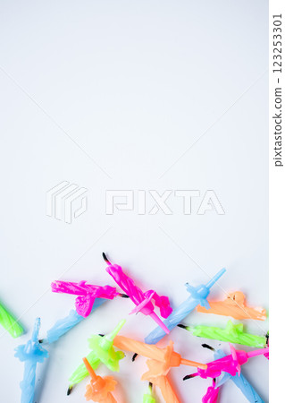 Colorful birthday candles arranged on white background 123253301
