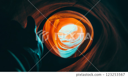 Dramatic rock formation with swirling orange and teal hues, contrasting light and shadow, creating an abstract geological spectacle. 123253567