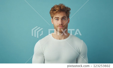 Portrait of a handsome, fair-skinned man with red hair and a beard, wearing a white shirt, looking directly at the viewer. 123253602
