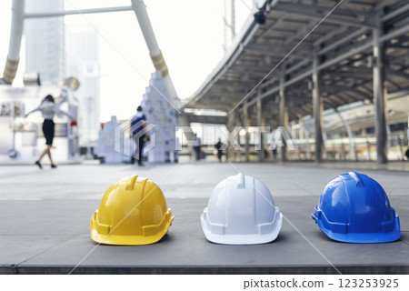Construction hard hat safety tools equipment for workers in construction site for engineering protection head standard. Many hard hat helmet on row with copy space. Engineering Construction Concept Construction hard hat safety tools equipment for workers in construction site for engineering protection head standard. Many hard hat helmet on row with copy space. Engineering Construction Concept 123253925