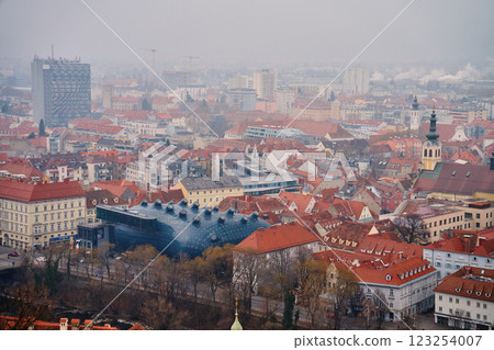 Graz cityscape on foggy day. Panoramic view of Graz, Austria with historical architecture. Streets with red roofed buildings in European city Graz cityscape on foggy day. Panoramic view of Graz, Austria with historical architecture. Streets with red roofed buildings in European city 123254007
