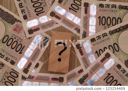 Question mark and paper money Question mark and paper money 123254409