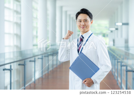 A man in a white coat working in a medical facility 123254538