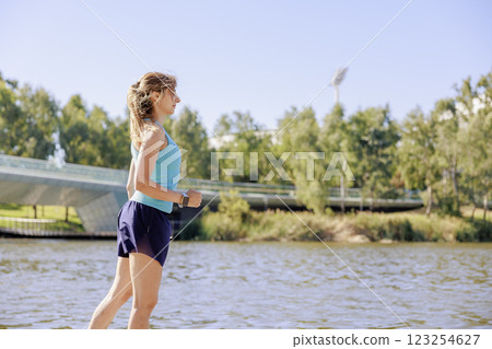 A woman in sportswear walking/jogging A woman in sportswear walking/jogging 123254627
