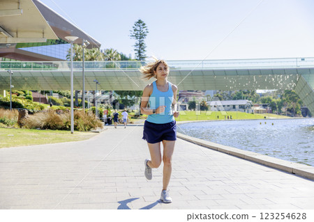 A woman in sportswear walking/jogging A woman in sportswear walking/jogging 123254628