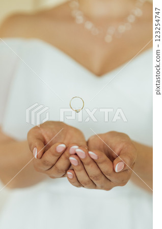 The bride in her wedding dress threw the ring in her hands. In the photo it looks like levitation The bride in her wedding dress threw the ring in her hands. In the photo it looks like levitation 123254747