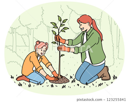 Little girl and mother plant tree in park, helping restore nature that has suffered from forest fire 123255841