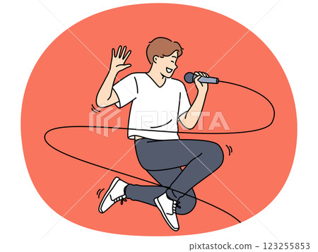 Jumping male singer with microphone enjoys performing energetic songs at karaoke party Jumping male singer with microphone enjoys performing energetic songs at karaoke party 123255853