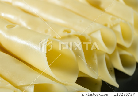 Semi-hard cheese, thin slices, rolled into tubes. Semi-hard cheese, thin slices, rolled into tubes. 123256737