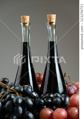 Balsamic vinegar in bottles among grapes 123256751