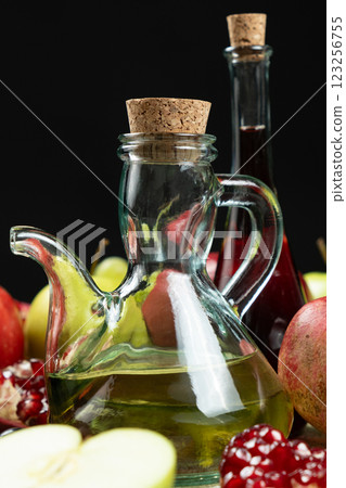 Vinegar in a glass vinegar bowl with a spout on a black background. 123256755