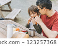 Close-up view of father hugs his school boy son on a family picnic in the mountains. Child kid and his dad taking a rest and enjoying a picnic while hiking in the mountains 123257368