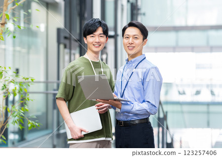 Engineers working in the office. Photo courtesy of Sky Perfect Tokyo Media Center. 123257406