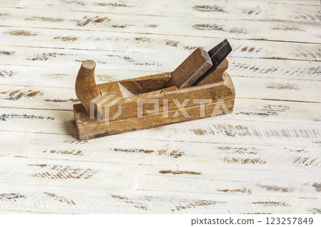 Hand carpentry tools. Planer for processing wood, wooden background 123257849