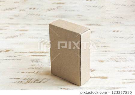 One small cardboard box on a wooden surface 123257850