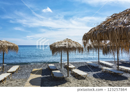 Seascape. An empty sea beach with sunbeds and umbrellas Seascape. An empty sea beach with sunbeds and umbrellas 123257864
