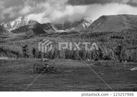 Peaceful landscape of mountains and field under cloudy sky in black and white 123257986