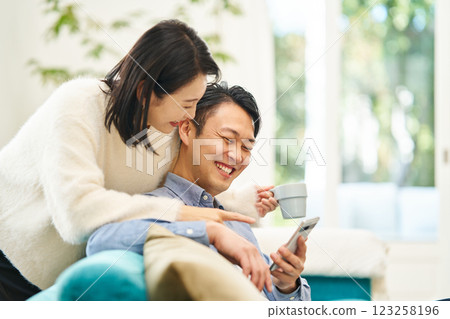 A couple looking at smartphones A couple looking at smartphones 123258196