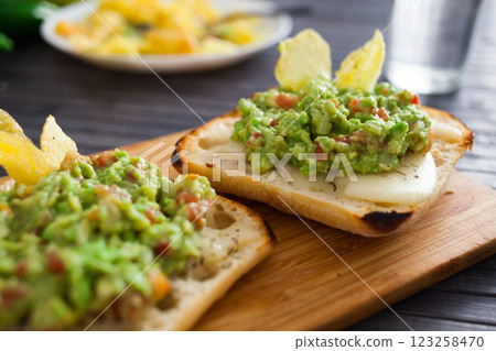 Morning toast with melted cheese and guacamol Morning toast with melted cheese and guacamol 123258470