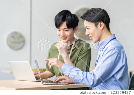 Engineering staff having a meeting. Filming cooperation: SKY Perfect Tokyo Media Center 123259427