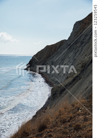 Beautiful landscape from the top of the cliff to the mountains and the sea beach Beautiful landscape from the top of the cliff to the mountains and the sea beach 123259545
