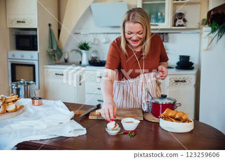 Female chef preparing delicious food in restaurant kitchen Female chef preparing delicious food in restaurant kitchen 123259606