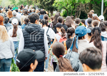 Crowd Lots of people walking down the road in spring Crowd Lots of people walking down the road in spring 123259705