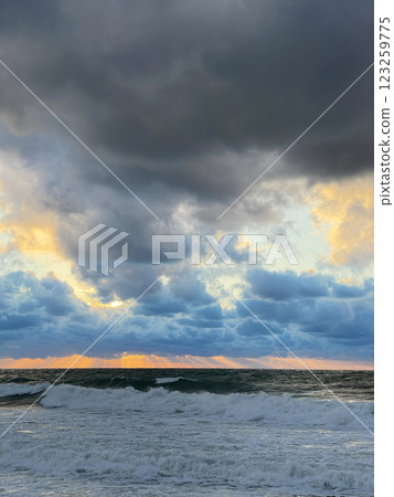 Storm at sea and sunset sky with clouds Storm at sea and sunset sky with clouds 123259775