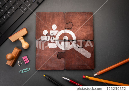 Employee and talent search. Wooden puzzle pieces with text on a dark office table Employee and talent search. Wooden puzzle pieces with text on a dark office table 123259852