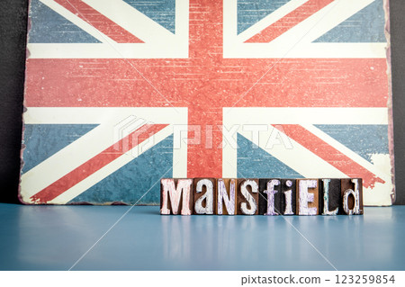 MANSFIELD. Urban Area in Great Britain. Flag and alphabet letters on wooden texture background 123259854