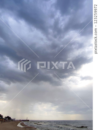 Rain and storm at sea. Dark storm clouds, rain and sea surface. Nature. Natural background. Stormy weather. Storm at sea. Big rain clouds Rain and storm at sea. Dark storm clouds, rain and sea surface. Nature. Natural background. Stormy weather. Storm at sea. Big rain clouds 123259972