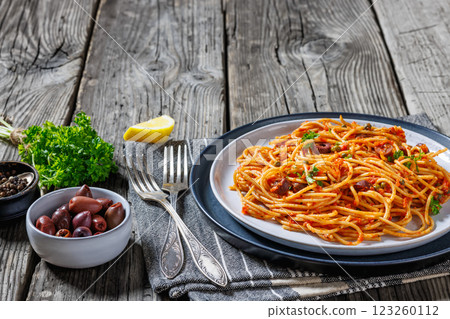 vegan whole grain pasta alla puttanesca on a plate 123260112