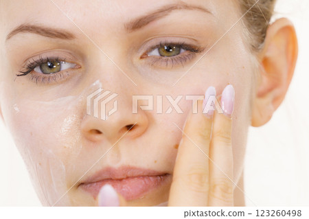 Girl apply cream cosmetic Girl apply cream cosmetic 123260498