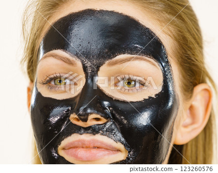 Girl black carbo peel off mask on face 123260576