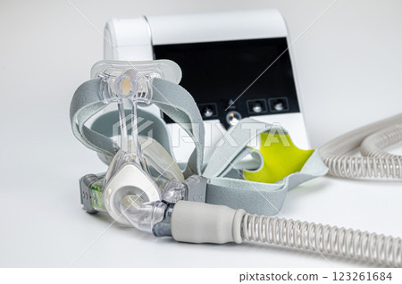 Continuous positive airway pressure system includes of CPAP machine, mask, tube on white background. Continuous positive airway pressure system includes of CPAP machine, mask, tube on white background. 123261684