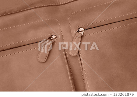 Stylish brown handbag featuring double zip pockets closeup 123261879