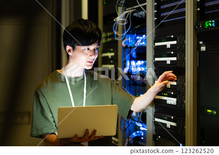 A young engineer performing server maintenance. Photo courtesy of Sky Perfect TV Tokyo Media Center. A young engineer performing server maintenance. Photo courtesy of Sky Perfect TV Tokyo Media Center. 123262520