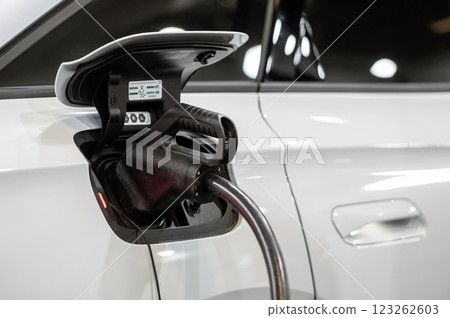 EV car connected to the charger, eco friendly technology EV car connected to the charger, eco friendly technology 123262603