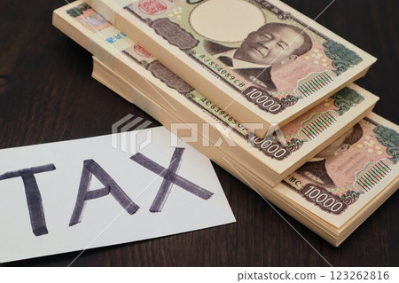 Photo of TAX and stack of bills Photo of TAX and stack of bills 123262816