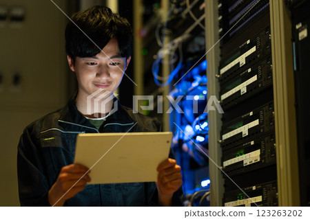 Engineers working in a server room. Photo courtesy of Sky Perfect Tokyo Media Center. Engineers working in a server room. Photo courtesy of Sky Perfect Tokyo Media Center. 123263202