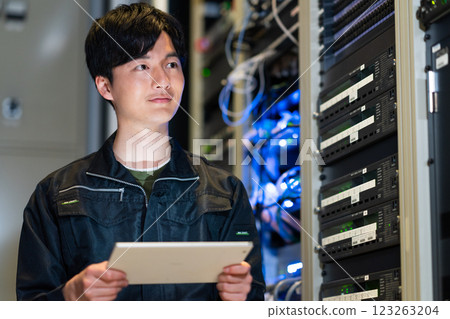Engineers working in a server room. Photo courtesy of Sky Perfect Tokyo Media Center. 123263204